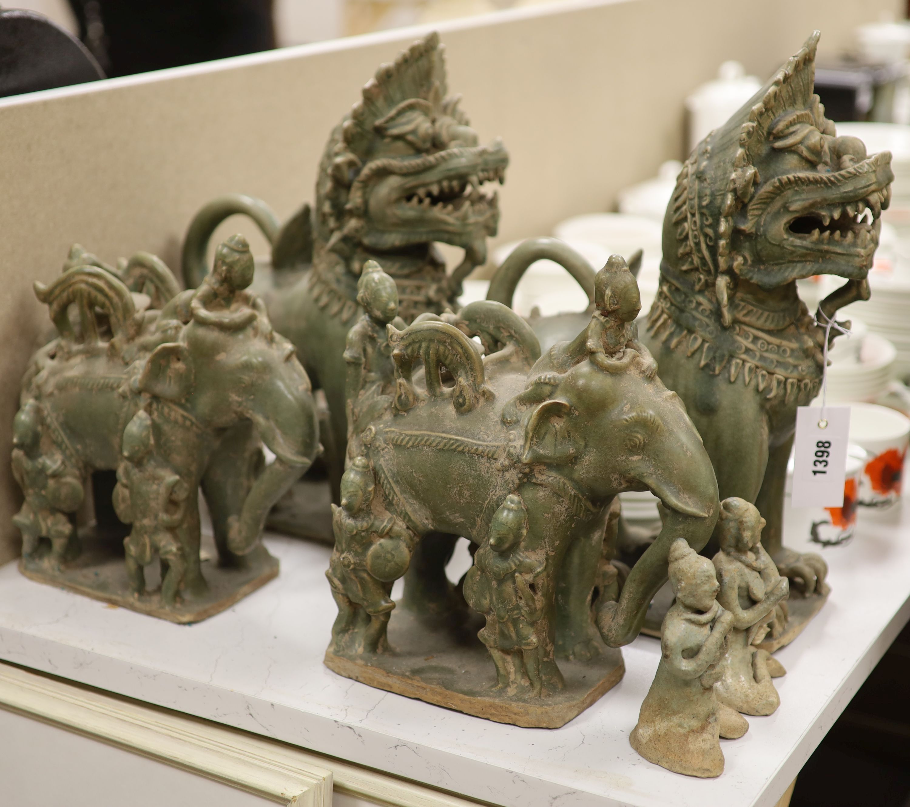 A group of Thai celadon glazed figures, temple dogs height 40cm